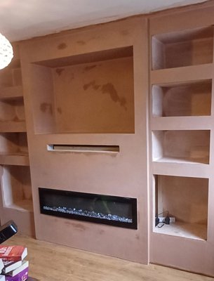 Plastered media wall with fireplace and shelving